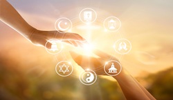 People holding out their hands to each other with icons of different world religions